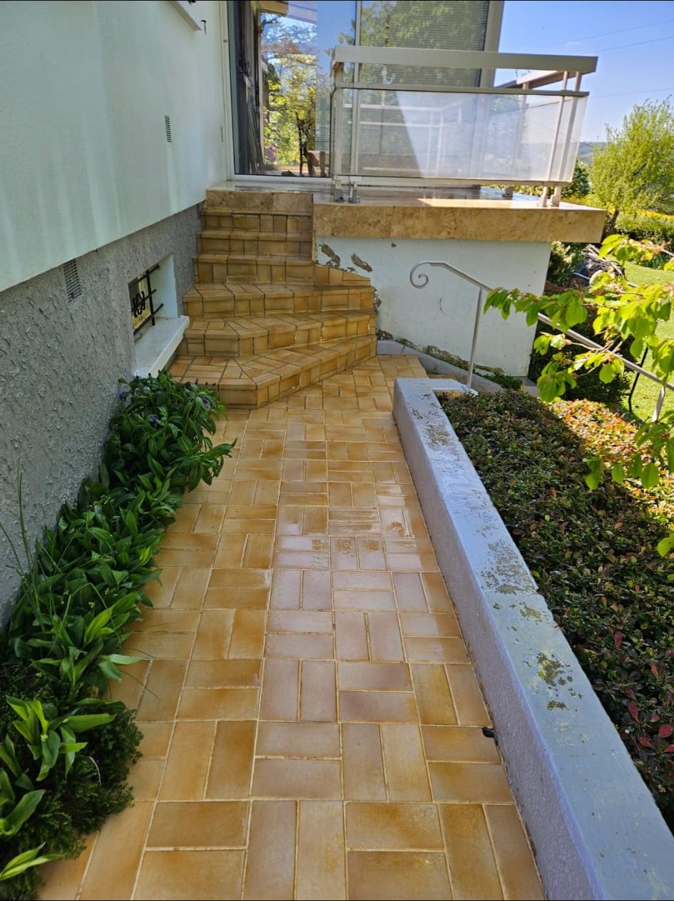 Allée et escalier carrelés, propres.